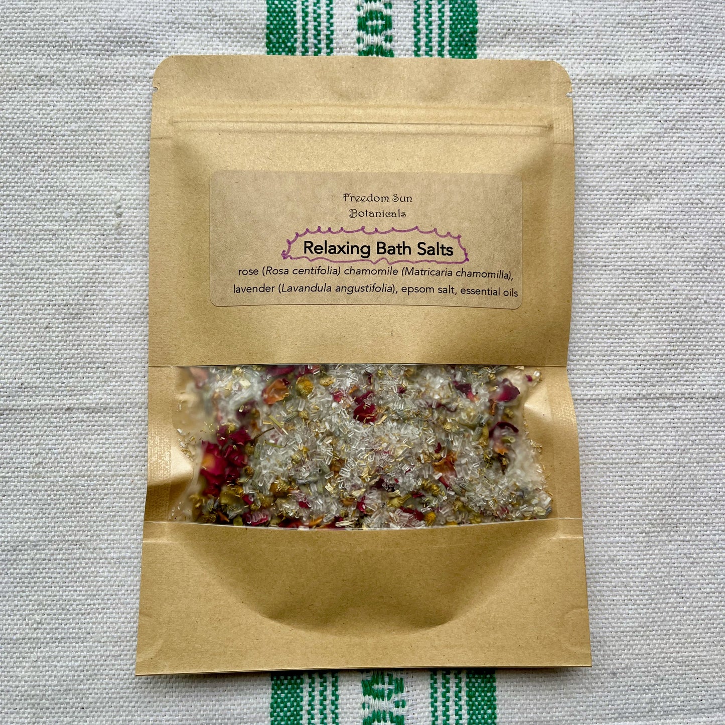 Kraft paper packaging of relaxing bath salts on a textured fabric background